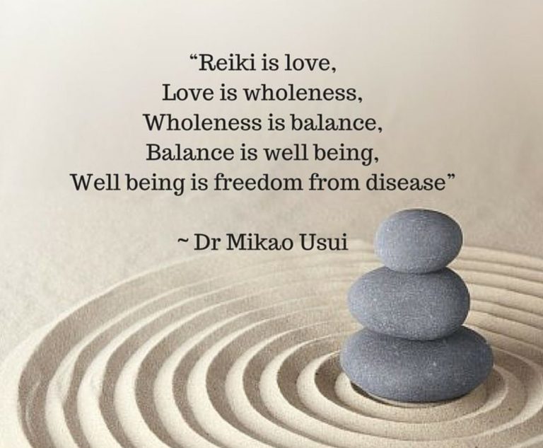 picture describing reiki with a pile of stones in the sand